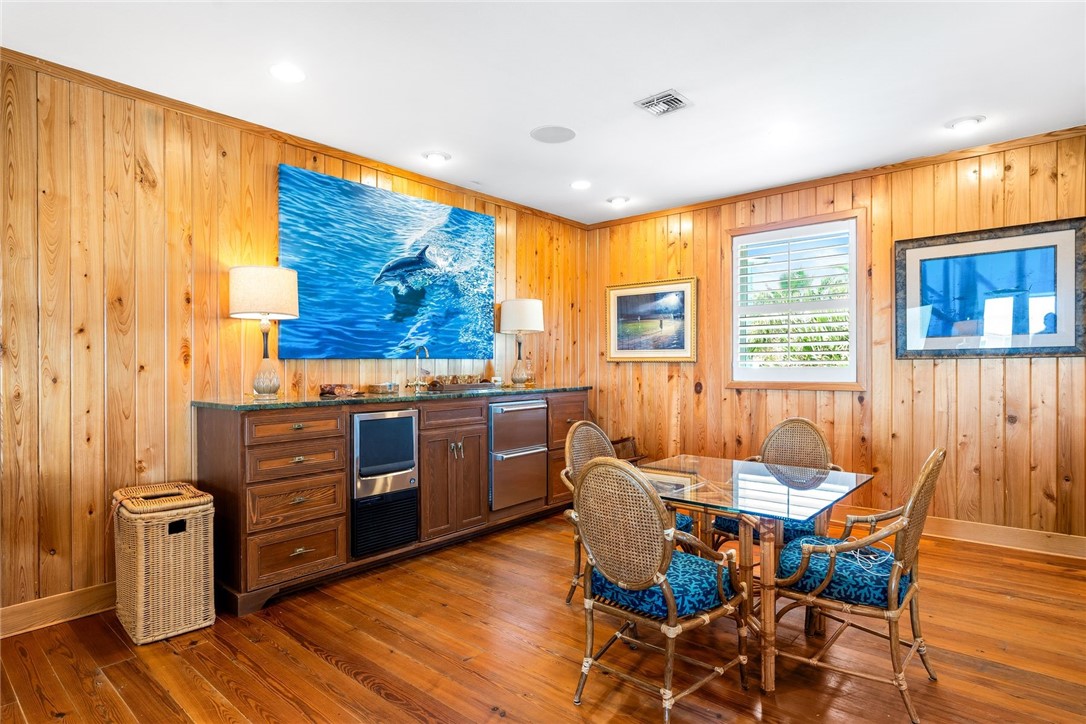 1024 Private Road East Port Aransas, TX 78373 - Photo 13 of 40 a kitchen with stainless steel appliances wooden floors and wooden cabinets