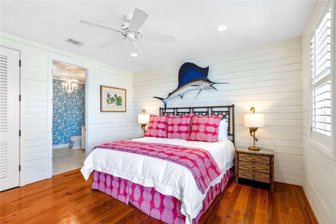1024 Private Road East Port Aransas, TX 78373 - Photo 15 of 40 a bedroom with a bed and wooden floor