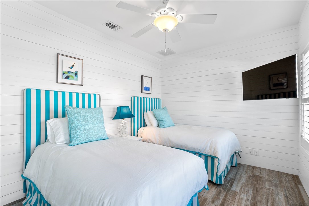 1024 Private Road East Port Aransas, TX 78373 - Photo 17 of 40 a bedroom with a bed and a flat tv screen on dresser