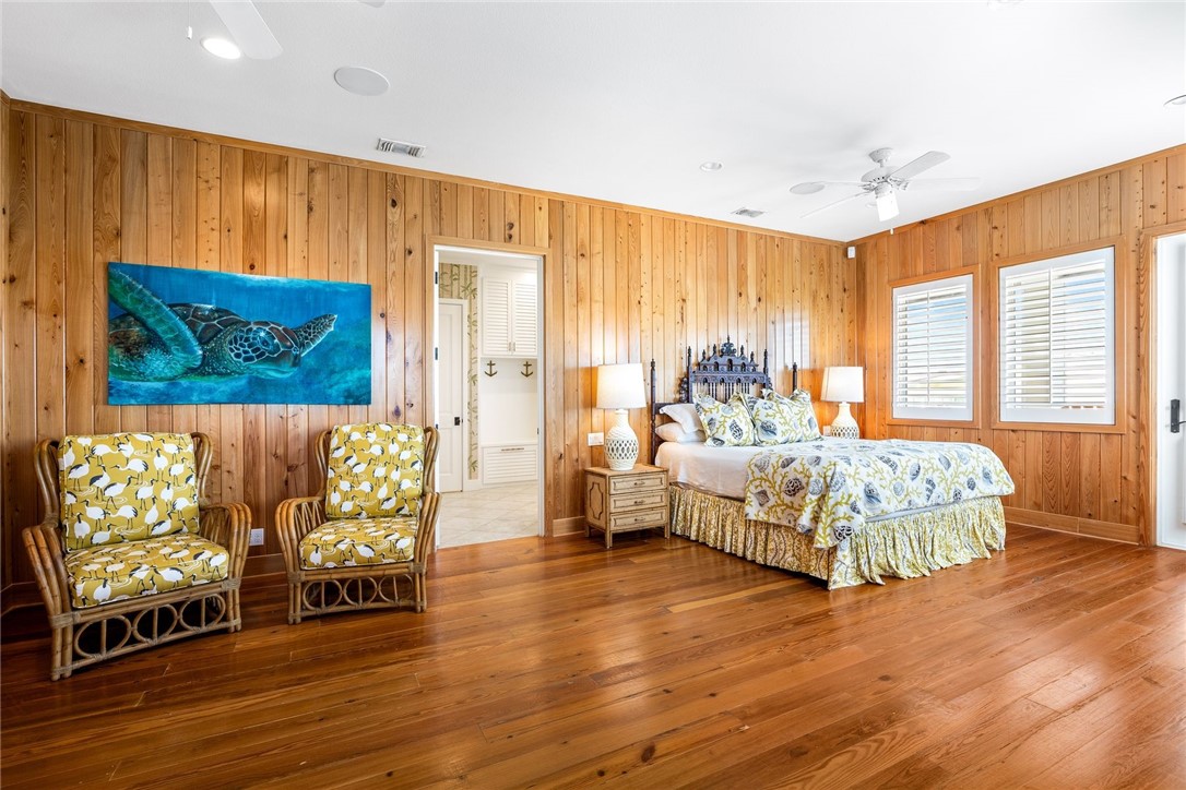 1024 Private Road East Port Aransas, TX 78373 - Photo 18 of 40 a bedroom with a bed and wooden floor