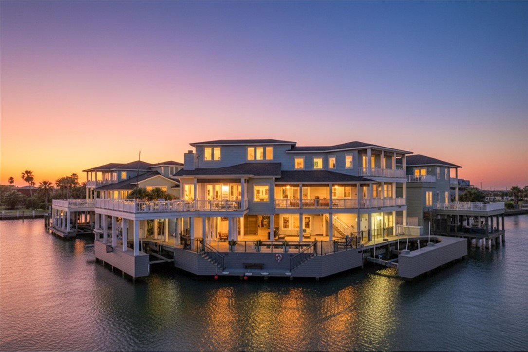 1024 Private Road East Port Aransas, TX 78373 - Photo 2 of 40 a view of a balcony with chairs and wooden floor