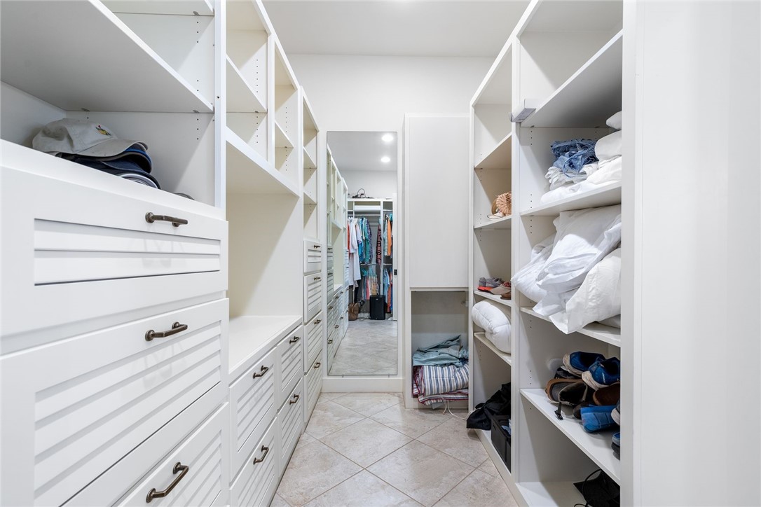 1024 Private Road East Port Aransas, TX 78373 - Photo 24 of 40 a view of walk in closet with clothes and shoes