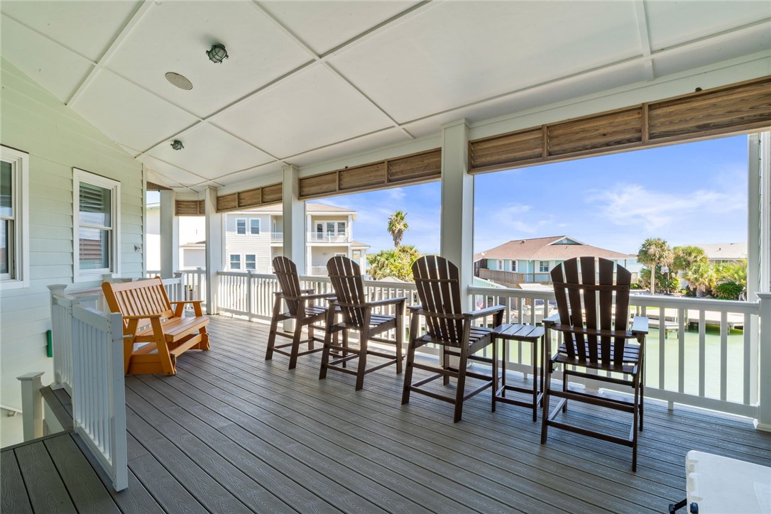 1024 Private Road East Port Aransas, TX 78373 - Photo 29 of 40 a view of a patio with table and chairs and wooden floor