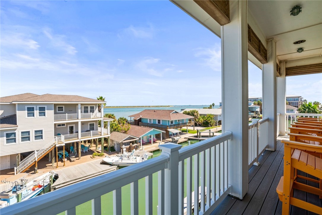 1024 Private Road East Port Aransas, TX 78373 - Photo 30 of 40 a view of a balcony with wooden floor and fence