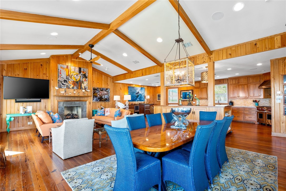 1024 Private Road East Port Aransas, TX 78373 - Photo 6 of 40 a view of a dining room with furniture wooden floor and a chandelier