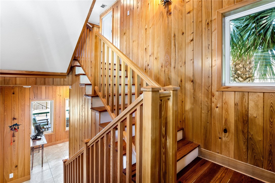 1024 Private Road East Port Aransas, TX 78373 - Photo 9 of 40 a view of front door with wooden floor and stairs
