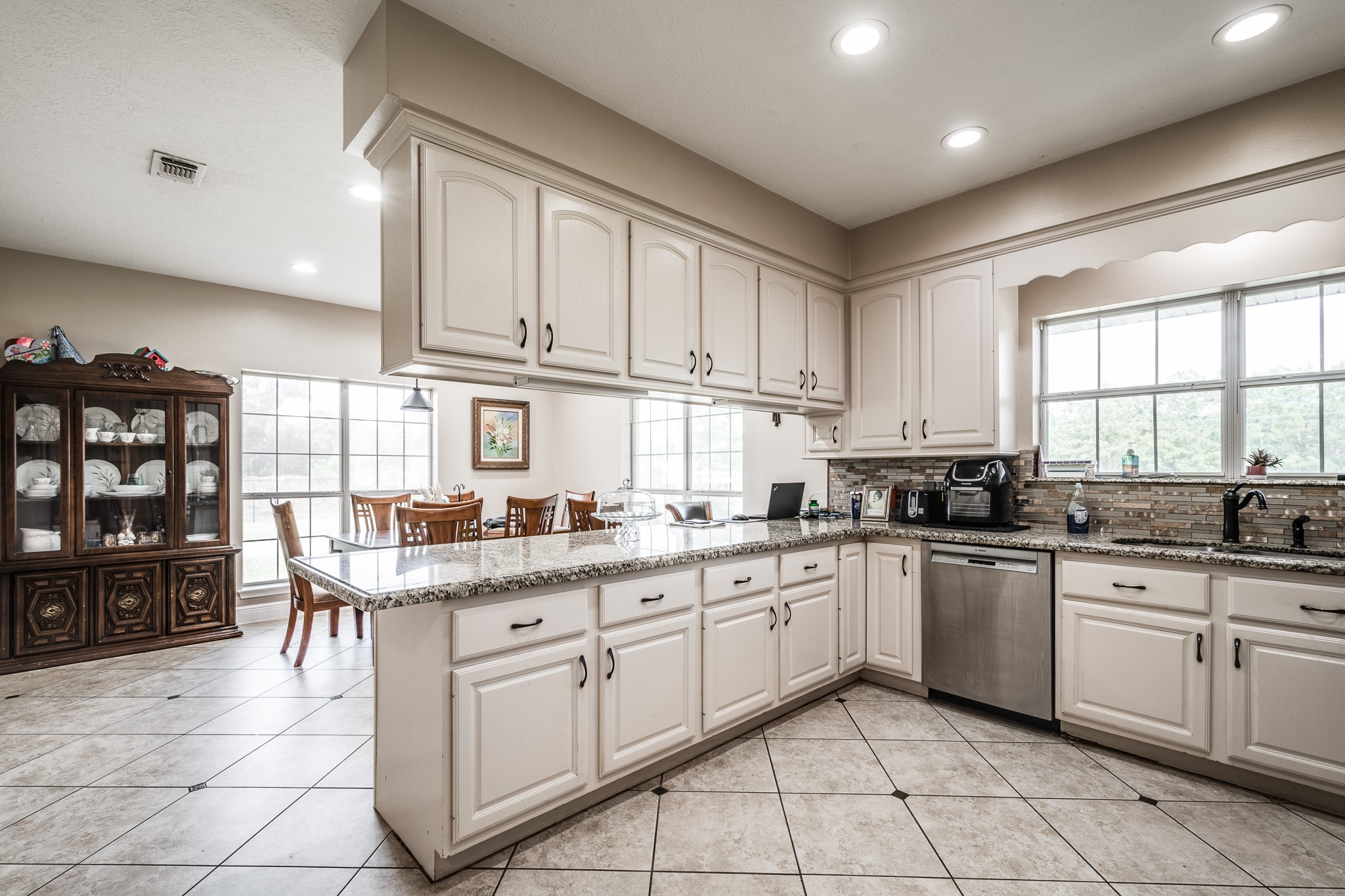 15953 1st Street Splendora, TX 77372 - Photo 11 of 23 a kitchen with cabinets appliances a sink and a window