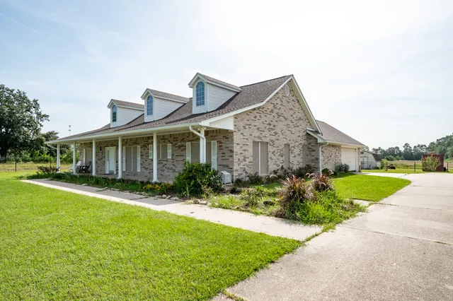 a front view of house with yard and green space