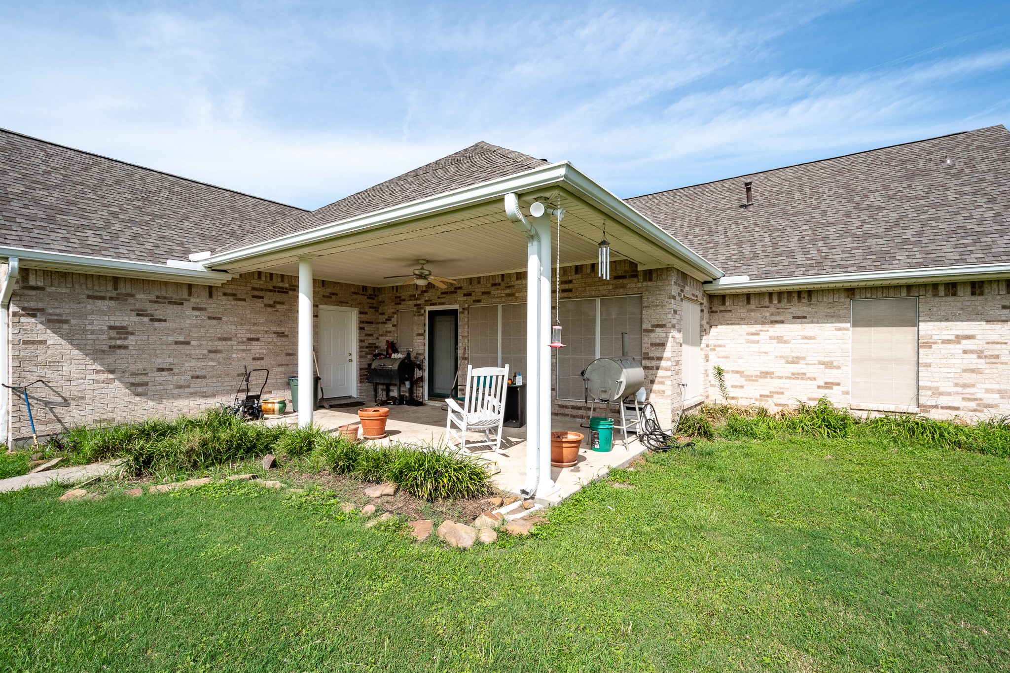 15953 1st Street Splendora, TX 77372 - Photo 18 of 23 a view of a house with brick walls and a yard with plants