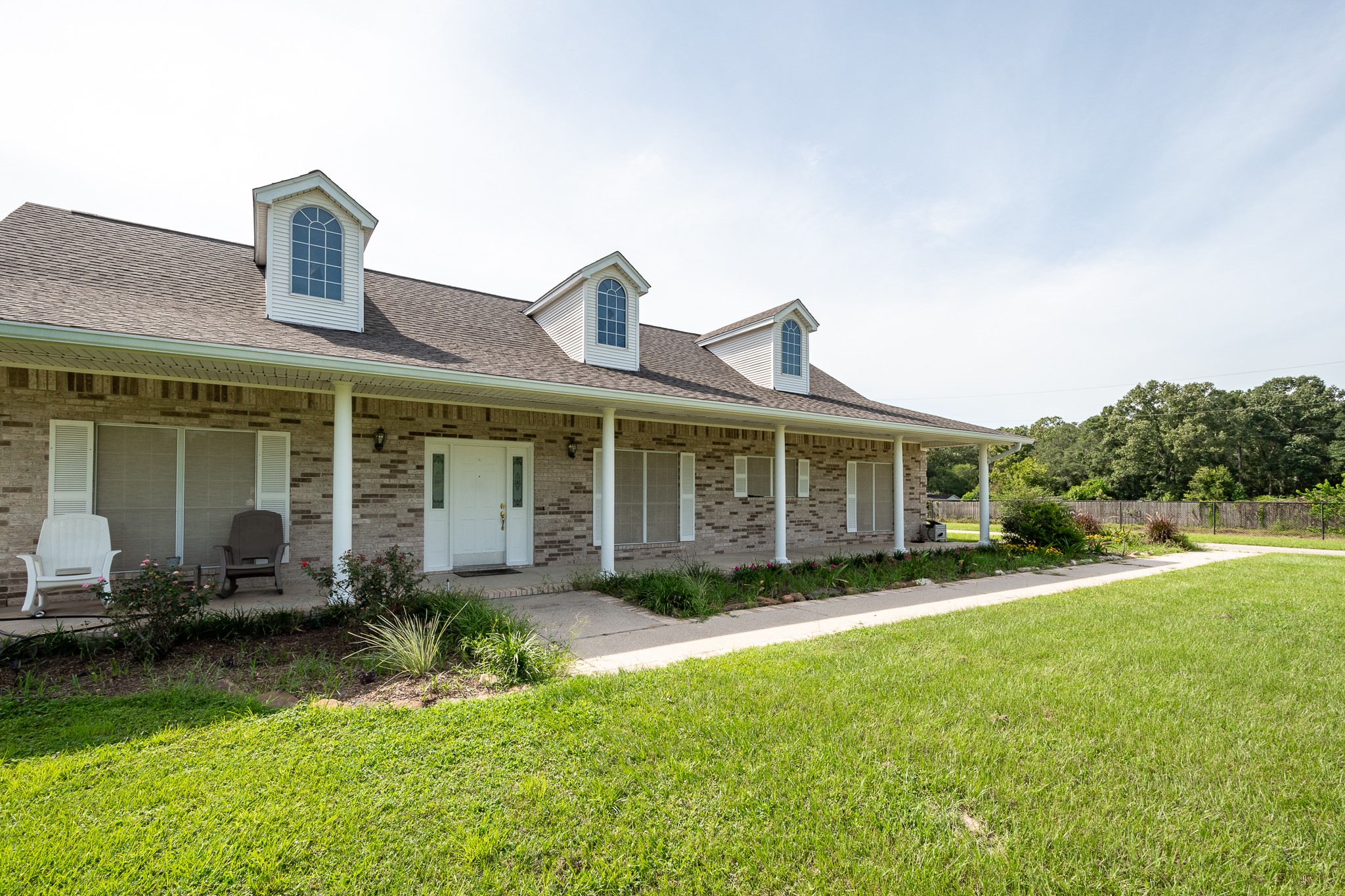 15953 1st Street Splendora, TX 77372 - Photo 3 of 23 a front view of a house with garden