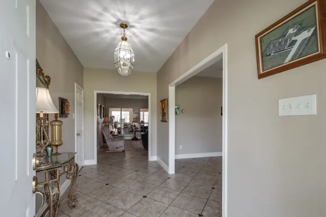 a view of a chandelier fan and entryway