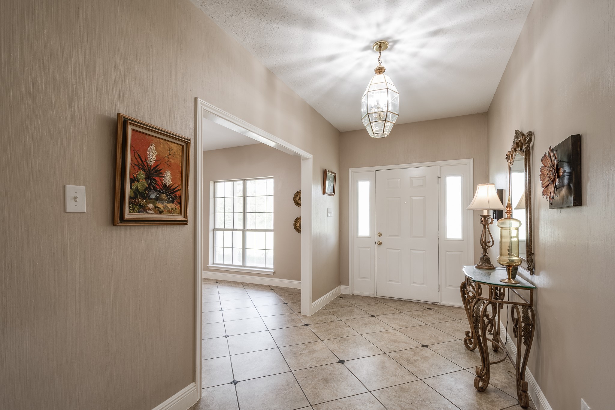 15953 1st Street Splendora, TX 77372 - Photo 5 of 23 a view of a hallway with windows and chandelier fan