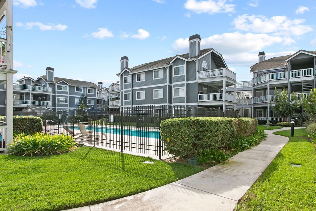 10411 Garden Grove Boulevard, Unit 43 Garden Grove, CA 92843 - Photo 20 of 22 a front view of multi story residential apartment building with a yard