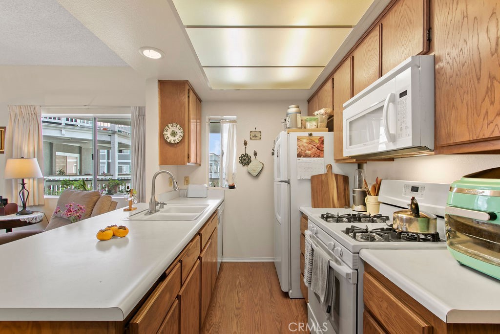 10411 Garden Grove Boulevard, Unit 43 Garden Grove, CA 92843 - Photo 5 of 22 a kitchen with stainless steel appliances granite countertop a lot of counter space and a refrigerator