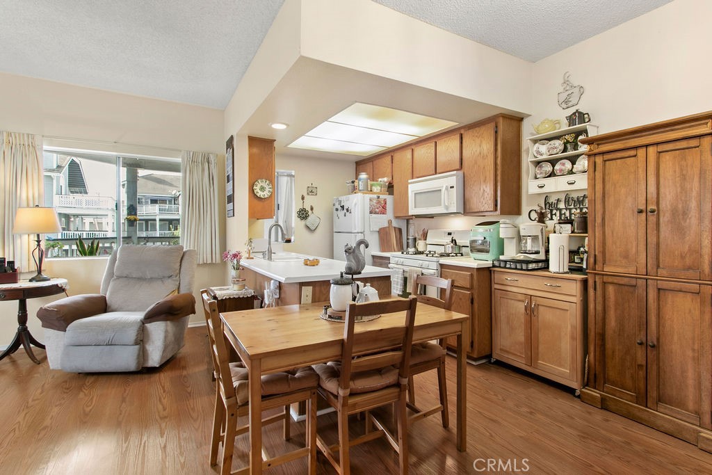 10411 Garden Grove Boulevard, Unit 43 Garden Grove, CA 92843 - Photo 7 of 22 a kitchen with a table chairs refrigerator and cabinets