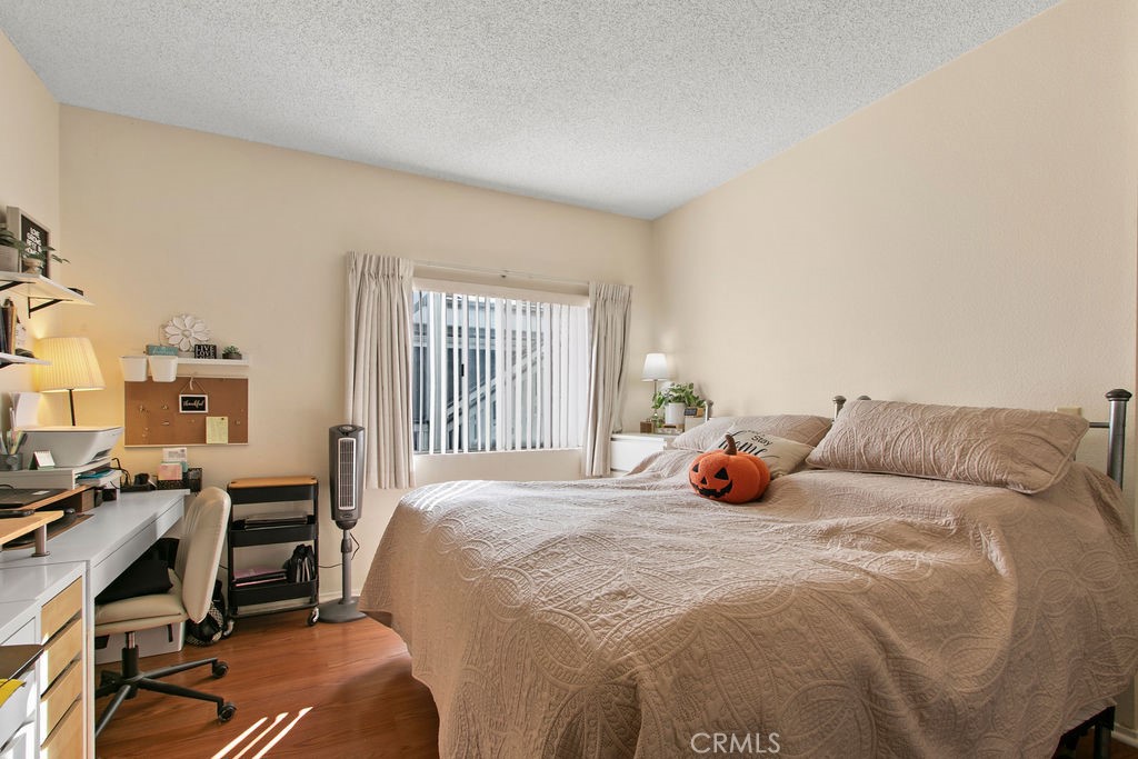 10411 Garden Grove Boulevard, Unit 43 Garden Grove, CA 92843 - Photo 9 of 22 a bedroom with a bed and a desk