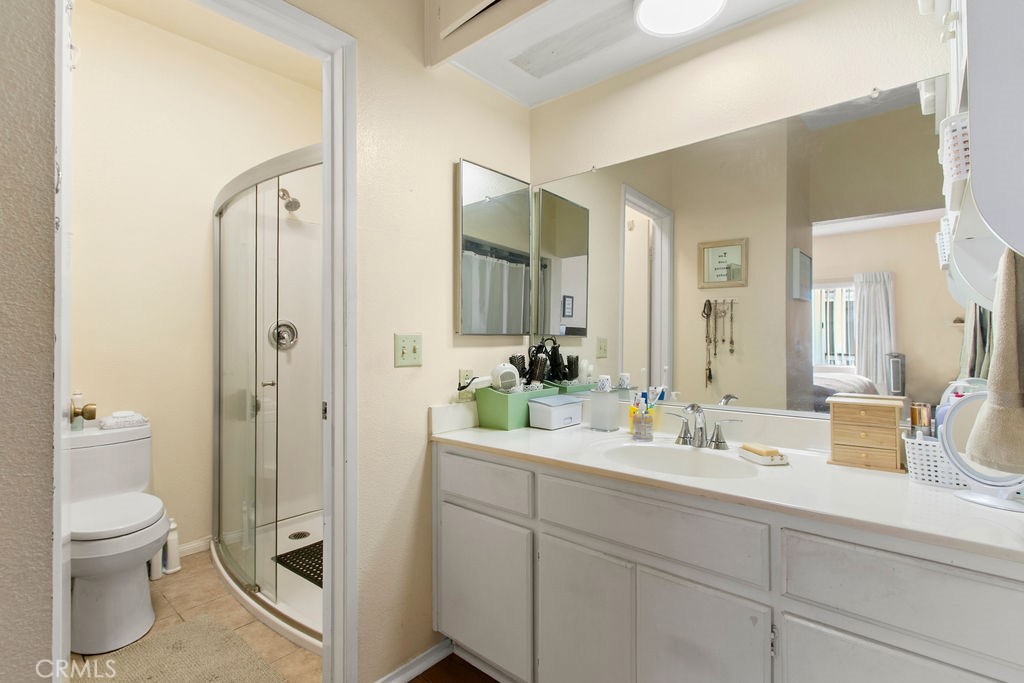 10411 Garden Grove Boulevard, Unit 43 Garden Grove, CA 92843 - Photo 10 of 22 a bathroom with a toilet a sink and mirror