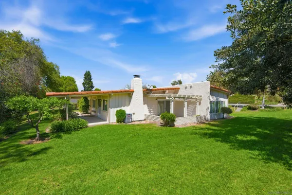 a front view of a house with a yard porch and sitting area