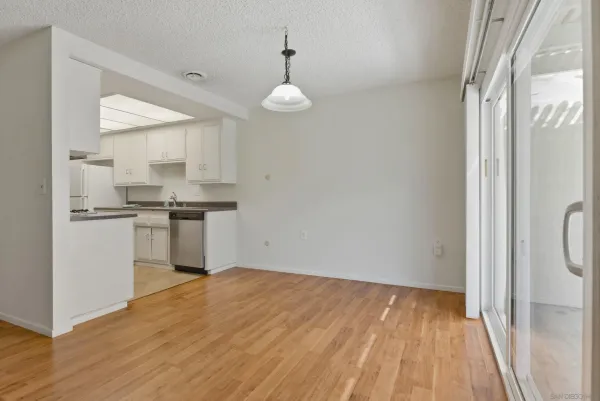 a view of kitchen with wooden floor electronic appliances and window