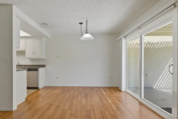 a view of a kitchen with a sink and dishwasher wooden floor