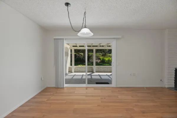 a view of a livingroom with a chandelier furniture and windows