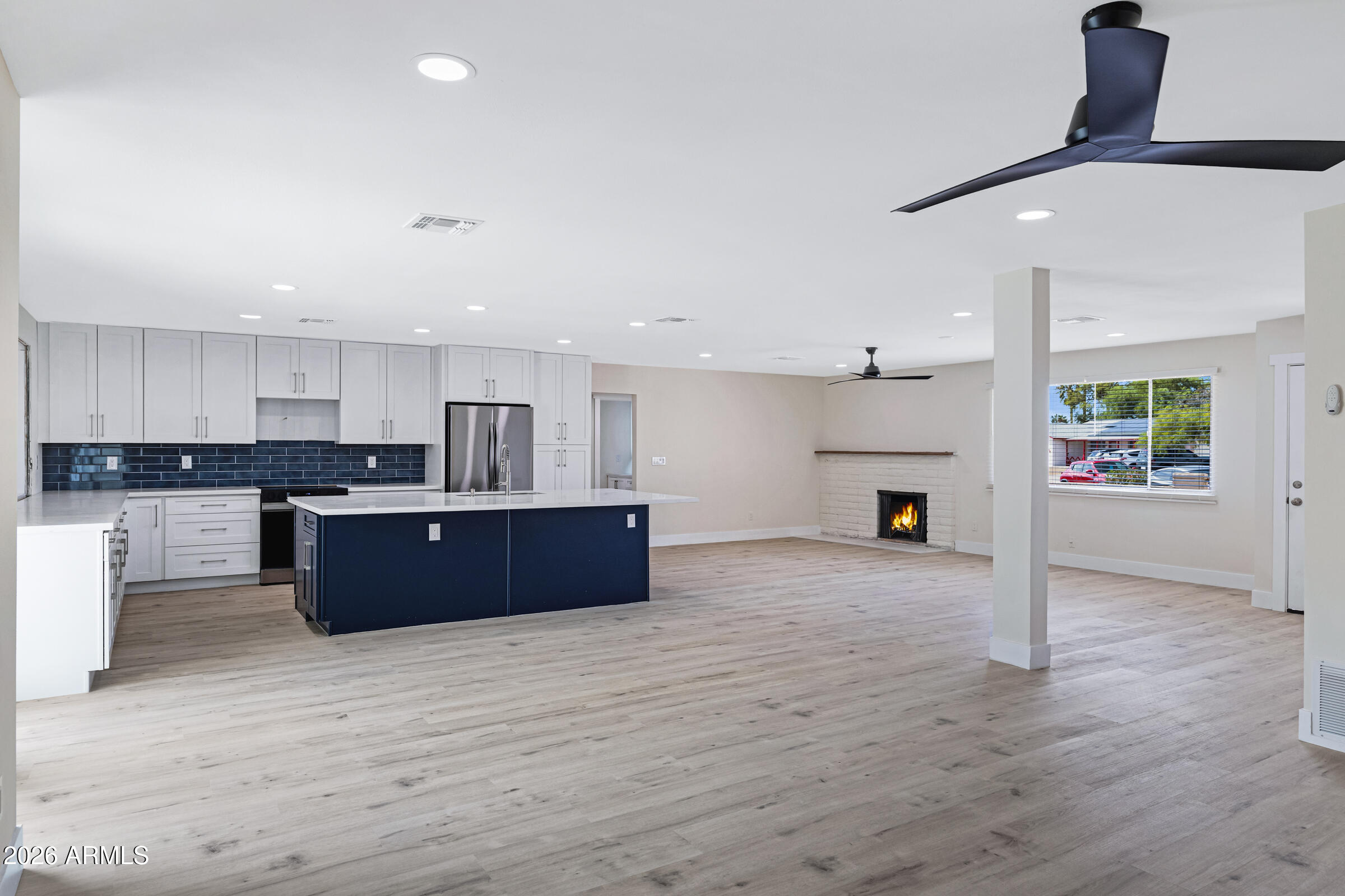 3921 South Kenneth Place Tempe, AZ 85282 - Photo 11 of 43 a kitchen with stainless steel appliances kitchen island wooden cabinets and granite counter tops