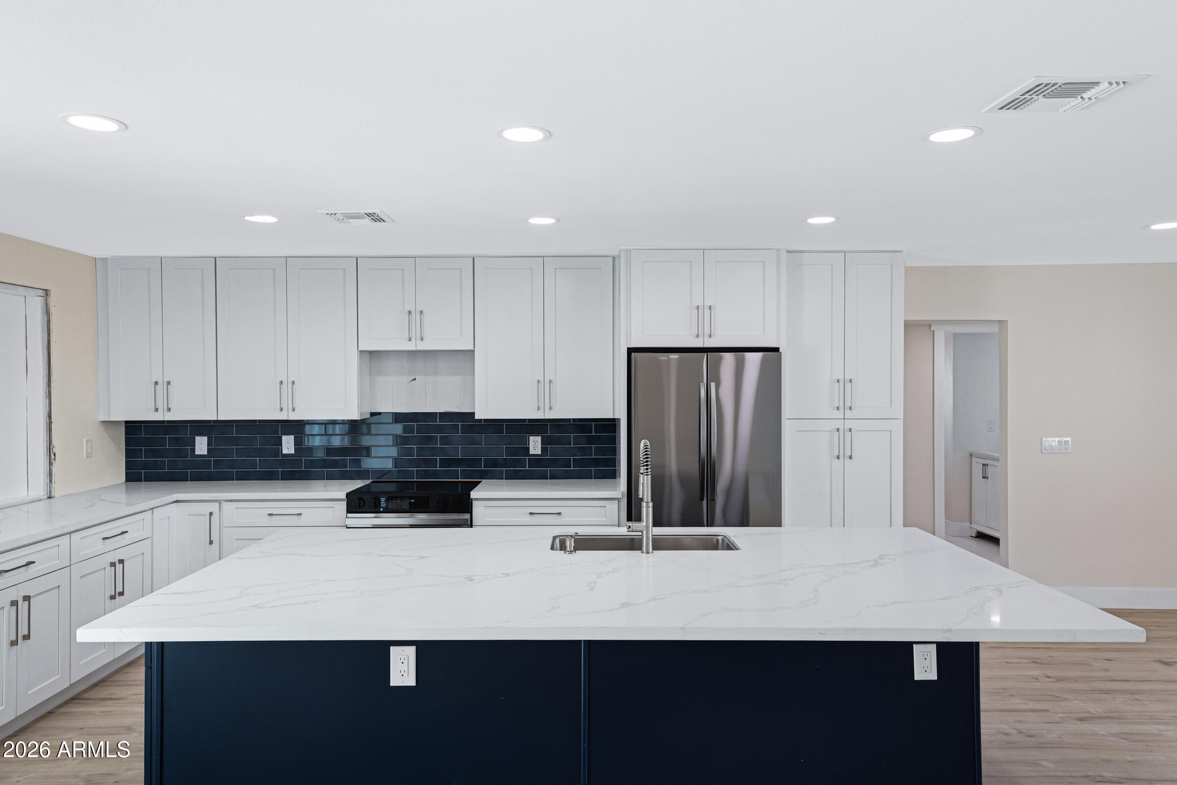 3921 South Kenneth Place Tempe, AZ 85282 - Photo 13 of 43 a kitchen with a refrigerator and a stove top oven
