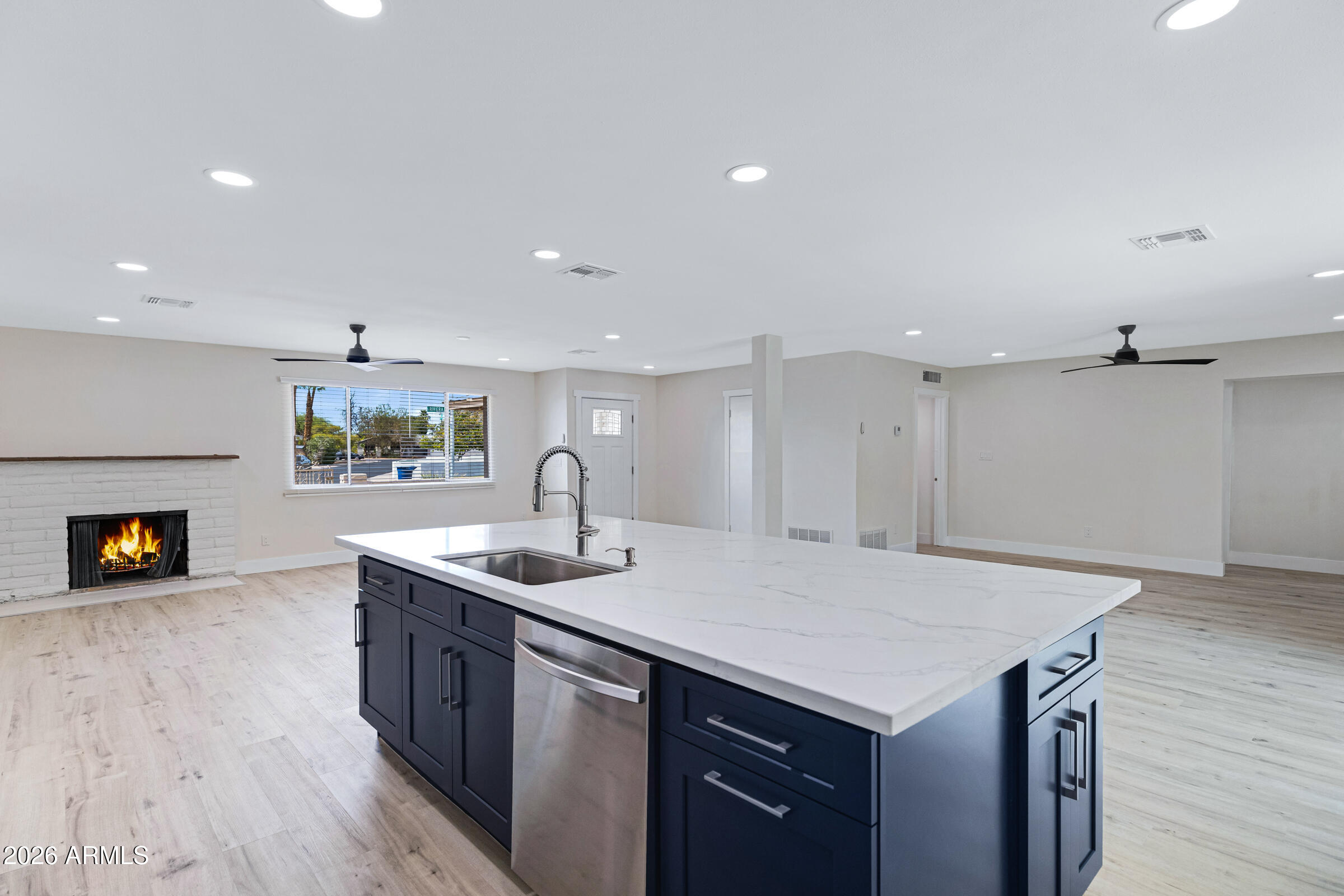 3921 South Kenneth Place Tempe, AZ 85282 - Photo 18 of 43 a kitchen with a sink a counter space and wooden floor