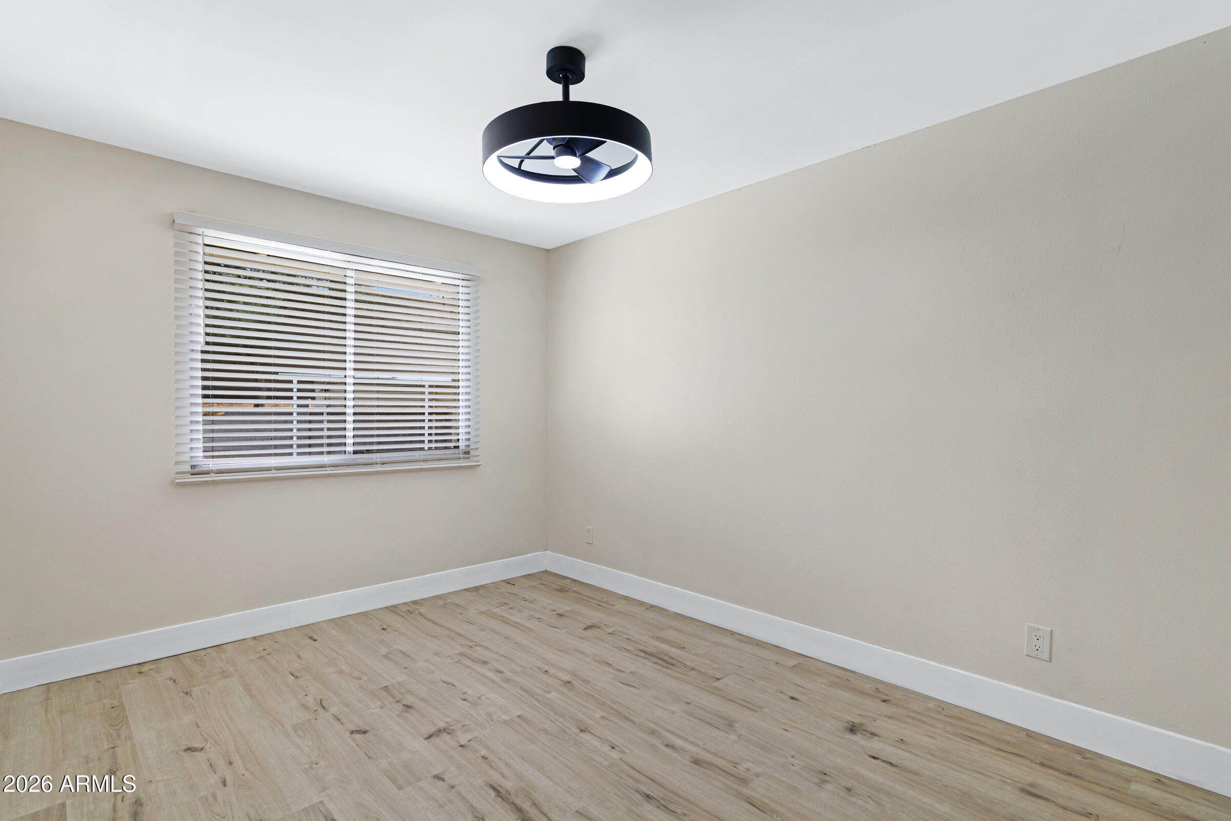 3921 South Kenneth Place Tempe, AZ 85282 - Photo 20 of 43 a view of empty room with wooden floor