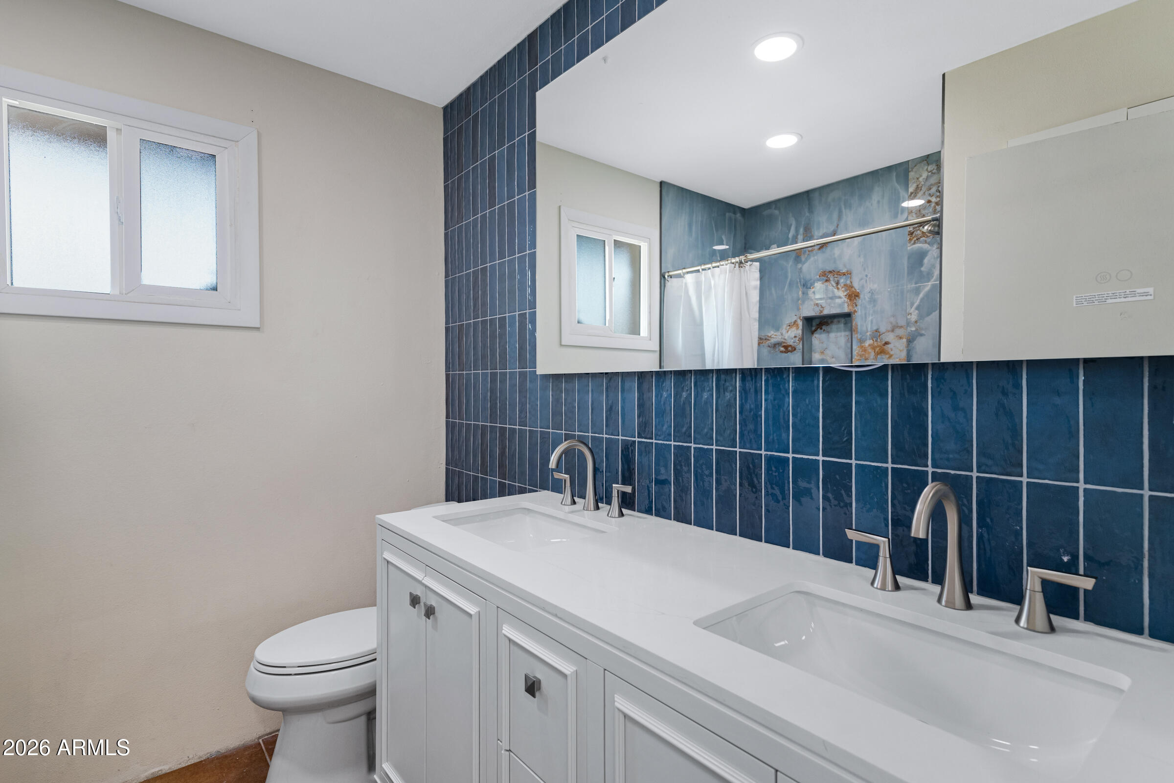 3921 South Kenneth Place Tempe, AZ 85282 - Photo 21 of 43 a bathroom with a sink and a toilet