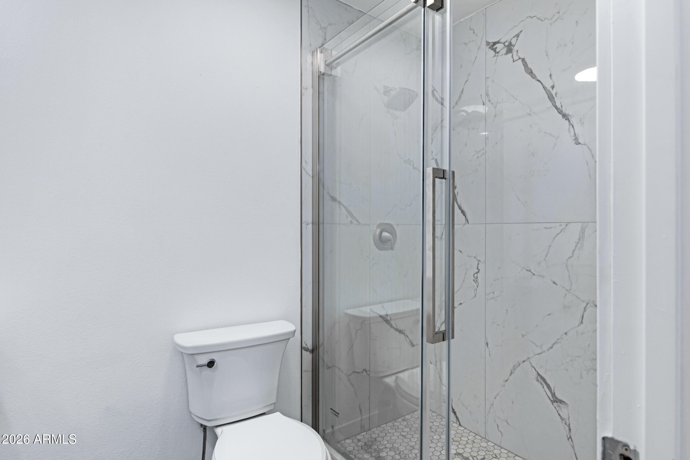 3921 South Kenneth Place Tempe, AZ 85282 - Photo 25 of 43 a white toilet sitting next to a bathroom