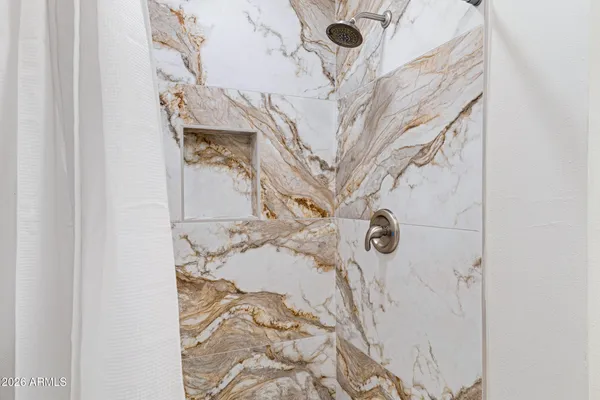 a bathroom with a bathtub and shower