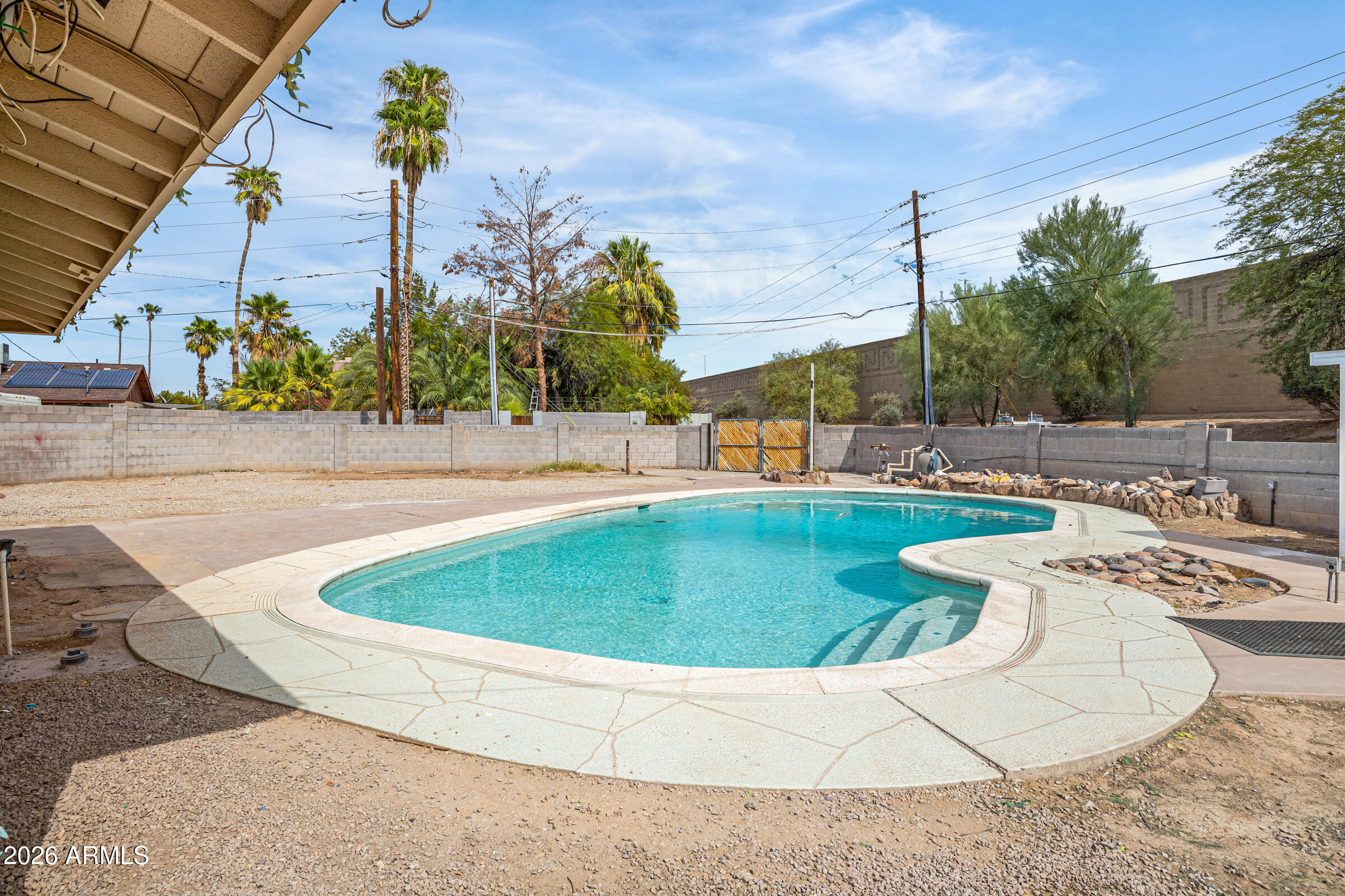 3921 South Kenneth Place Tempe, AZ 85282 - Photo 39 of 43 a view of a swimming pool with a yard