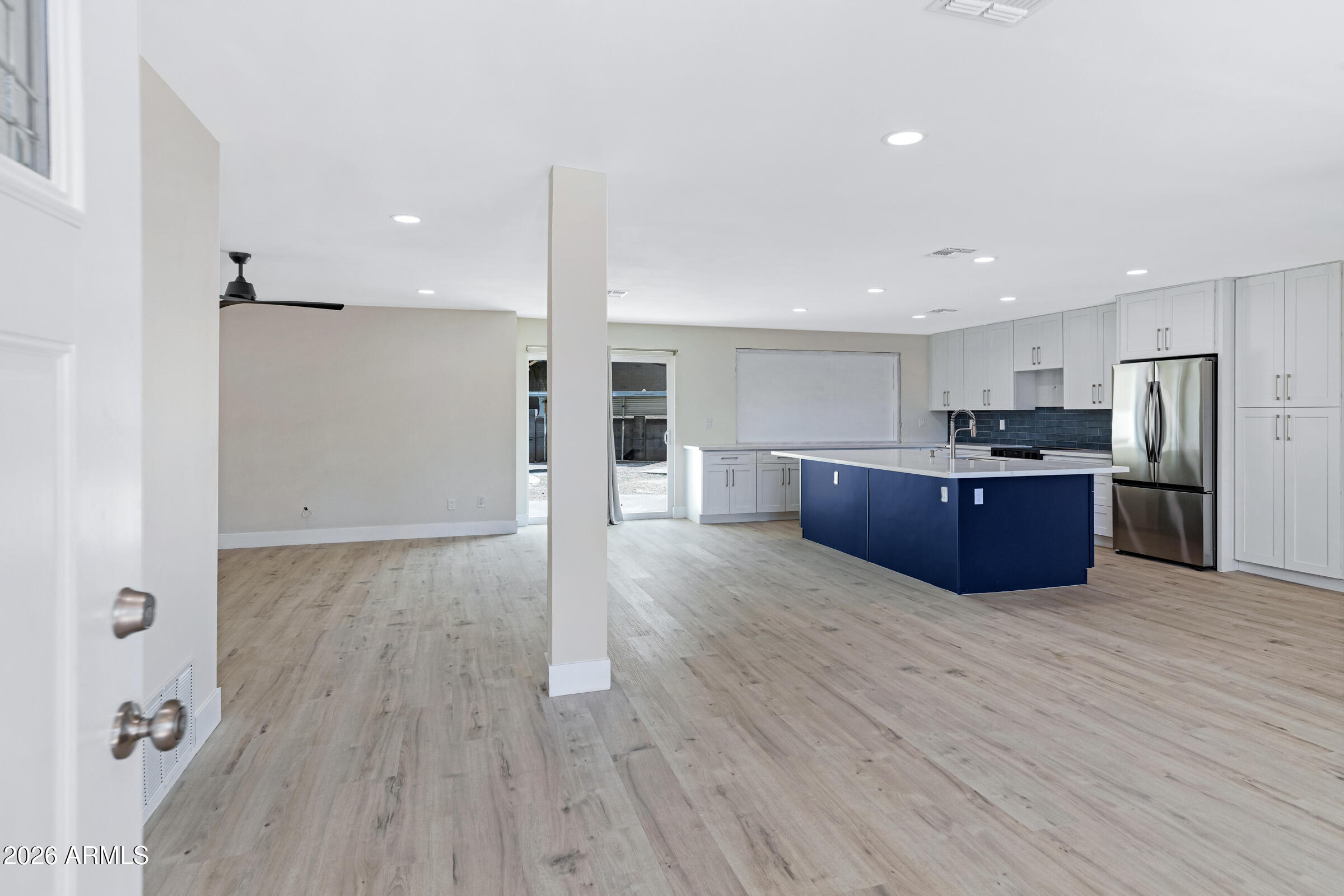 3921 South Kenneth Place Tempe, AZ 85282 - Photo 6 of 43 a large kitchen with wooden floors and stainless steel appliances
