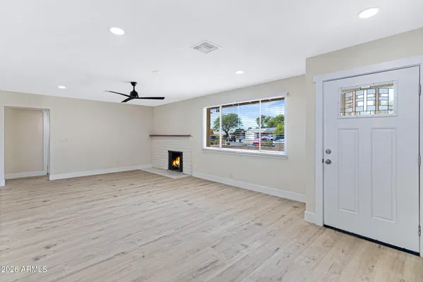 wooden floor in an empty room with a window