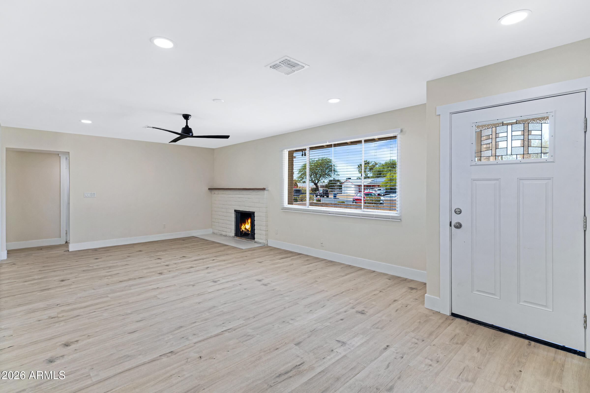 3921 South Kenneth Place Tempe, AZ 85282 - Photo 7 of 43 wooden floor in an empty room with a window