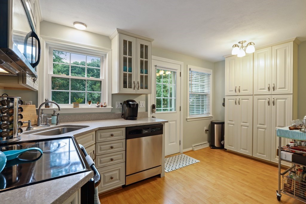 23 Clough Road, Unit 23 Dedham, MA 02026 - Photo 12 of 27 a kitchen with a stove a sink and a refrigerator