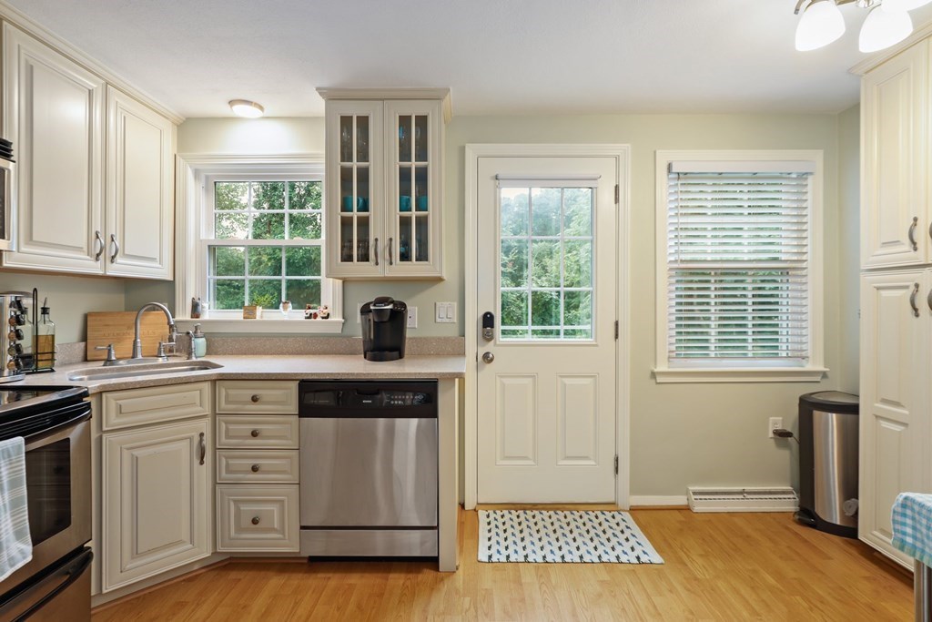 23 Clough Road, Unit 23 Dedham, MA 02026 - Photo 13 of 27 a kitchen with stainless steel appliances granite countertop a stove a sink and a window
