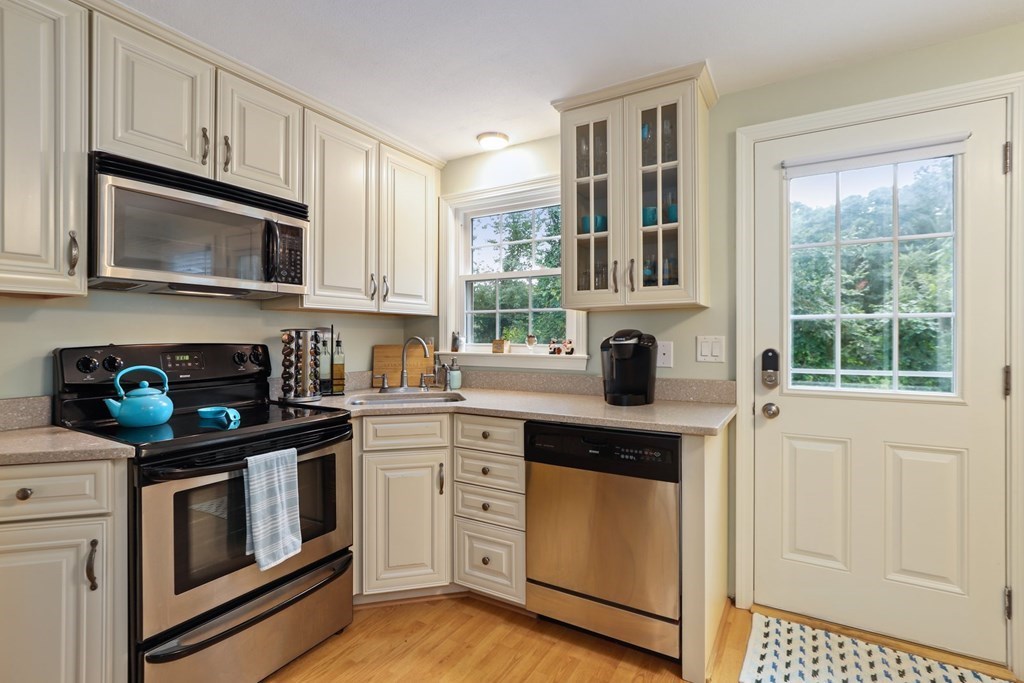 23 Clough Road, Unit 23 Dedham, MA 02026 - Photo 14 of 27 a kitchen with cabinets stainless steel appliances and a window