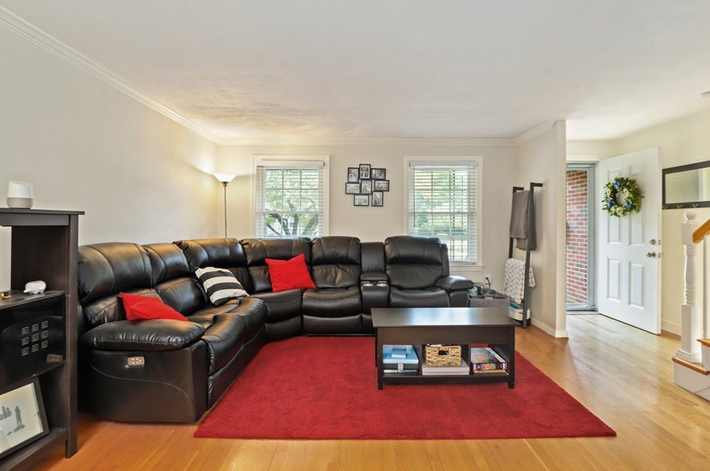 23 Clough Road, Unit 23 Dedham, MA 02026 - Photo 4 of 27 a living room with furniture and a wooden floor