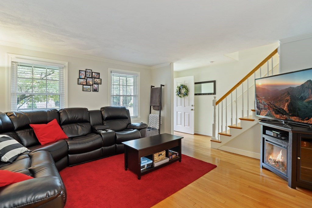 23 Clough Road, Unit 23 Dedham, MA 02026 - Photo 5 of 27 a living room with furniture a window and a flat screen tv
