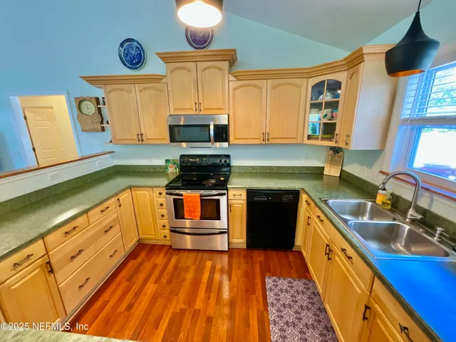 a bedroom with bed and a chandelier