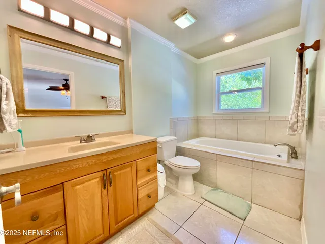 a spacious bedroom with a bed and a chandelier