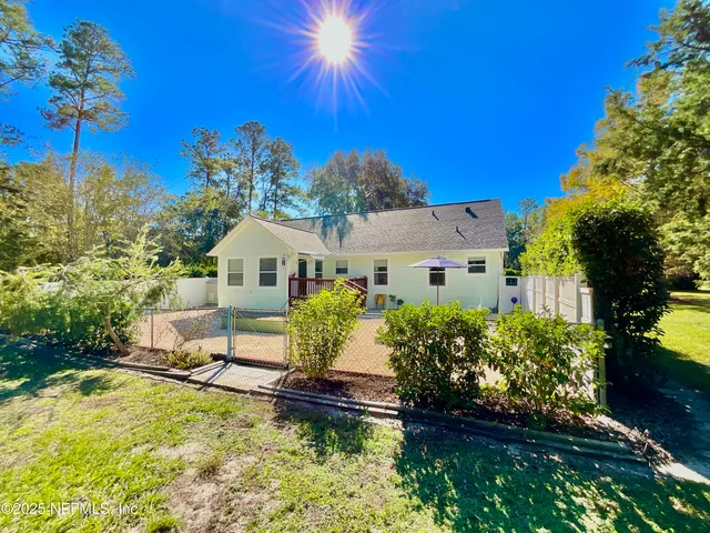 a view of a house with a yard and sitting area