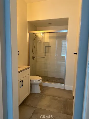 a bathroom with a toilet and shower