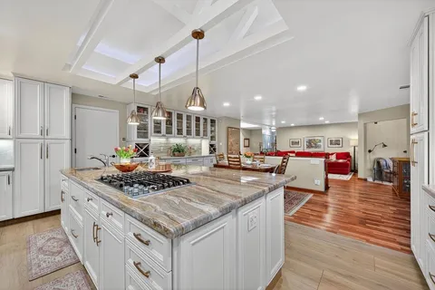 a kitchen with a sink a counter space stainless steel appliances and cabinets
