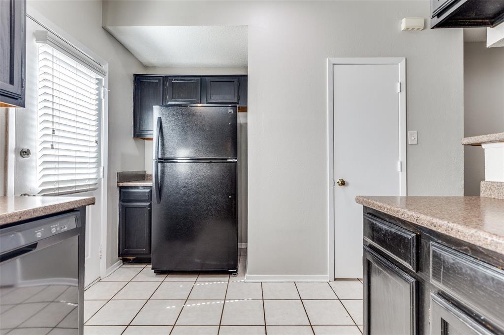 633 Carriagehouse Lane, Unit I6 Garland, TX 75040 - Photo 11 of 24 a kitchen with a refrigerator and a stove
