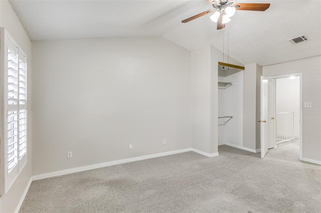 633 Carriagehouse Lane, Unit I6 Garland, TX 75040 - Photo 14 of 24 an empty room with a window and a chandelier fan