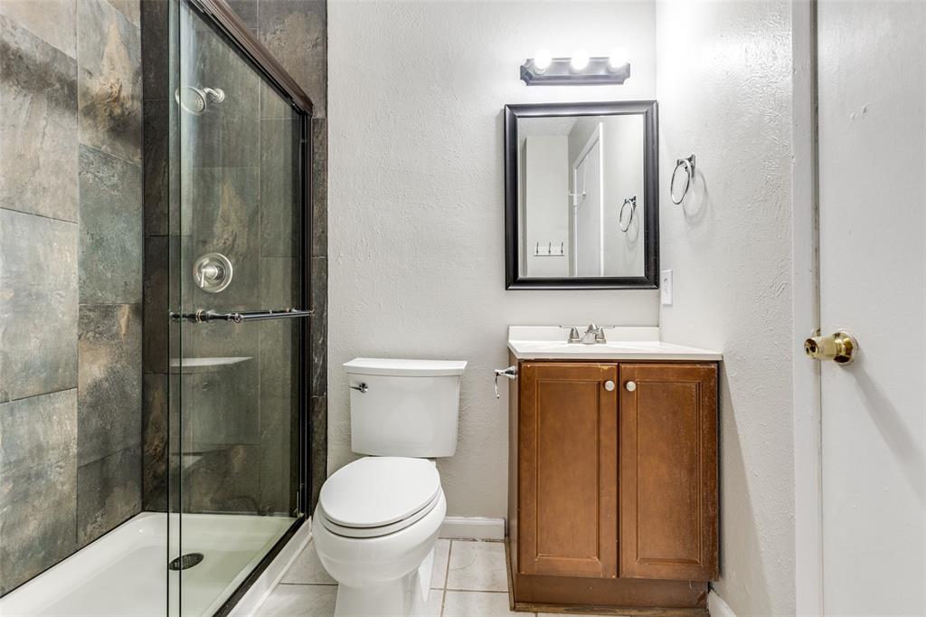 633 Carriagehouse Lane, Unit I6 Garland, TX 75040 - Photo 15 of 24 a bathroom with a toilet sink and shower