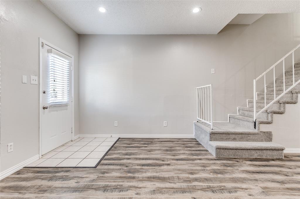 633 Carriagehouse Lane, Unit I6 Garland, TX 75040 - Photo 3 of 24 a view of staircase with white walls and white walls